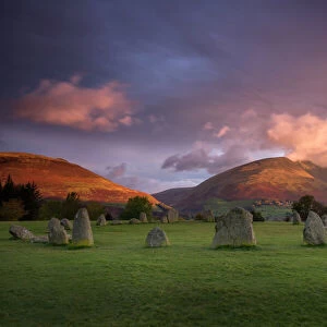 Castlerigg Stone Circle in autumn at sunrise with Blencathra bathed in dramatic dawn light