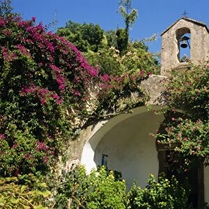 Chapel and bell tower covered in lantana and bougainvillea