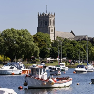 Christchurch Priory and pleasure boats on the River Stour, Dorset, England