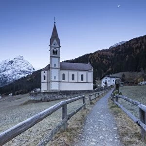 Church of Trafoi during frozen twilight with moon in the sky, Trafoi, Stelvio National Park