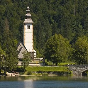 Church in village, bridge over Bohinj Lake, Slovenia, Europe
