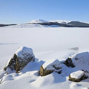 Clatteringshaws Loch, frozen and covered in winter snow, Dumfries and Galloway, Scotland, United Kingdom, Europe