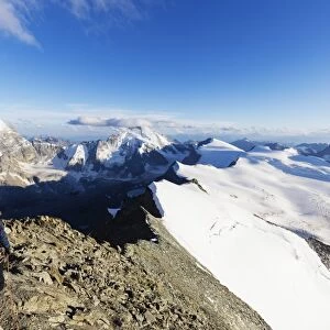 Climber on south ridge of Dent Blanche, 4357m, with view to the Matterhorn, Valais