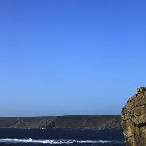 A climber tackles a difficult route on the cliffs near Sennen Cove, a popular rock climbing area at Lands End, Cornwall, England, United