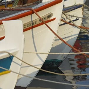 Close up of the front of three fishing boats in the harbour