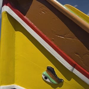 Close-up of a brightly coloured fishing boat (Luzzus) with the eye of Osiris to ward off evil at Marsaxlokk, a fishing village