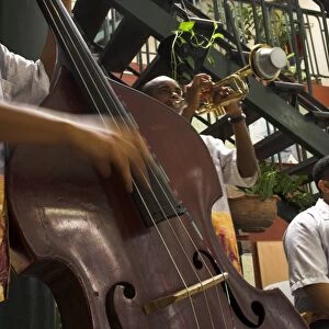 Close-up of counterbass with trumpet player, part of traditional band playing in a cafe