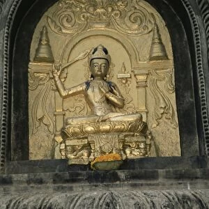 Close-up of gold relief carving of Manjushri