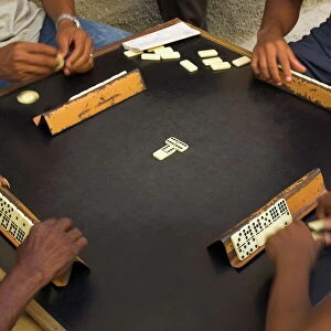 Close-up of the hands of a group of four people playing dominos in the street Centro Habana