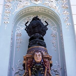 Close-up of a statue in an alcove on the facade of the art nouveau building