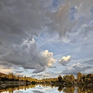 Clouds at sunset reflected in an unnamed lake, Shoshone National Forest, Wyoming, United States of America, North America