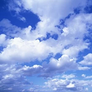 Cloudscape of puffy white clouds in a blue sky