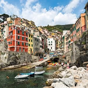 The colourful buildings and boats in Riomaggiore harbour, Cinque Terre, UNESCO World Heritage Site