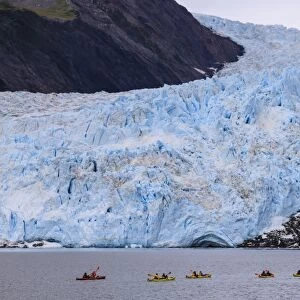 Colourful kayaks, Aialik Glacier, blue ice and mountains, Harding Icefield, Kenai