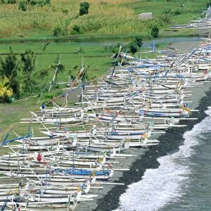Colourful prahu (fishing boats) lining the beach