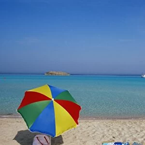 Colourful umbrella on Playa de ses Illetes beach