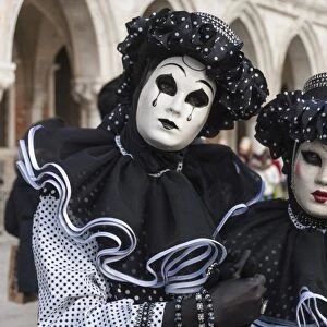 Couple in black and white with clown puppet, Venice Carnival, Venice, Veneto, Italy
