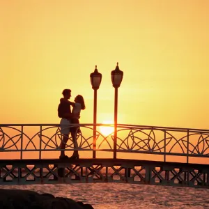 Couple on bridge at sunset, Aruba, West Indies, Dutch Caribbean, Central America