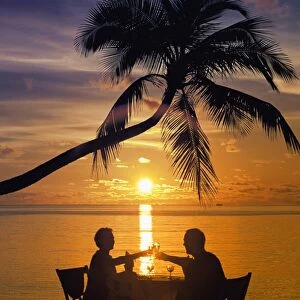 Couple having dinner at the beach, toasting glasses, Maldives, Indian Ocean, Asia
