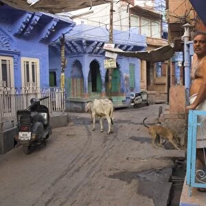 Couple standing outside blue painted residential haveli