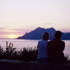 Couple watching sunset near Porto, Corsica, France, Mediterranean, Europe