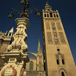 Decorative lamps and the Giralda tower in the city of Seville