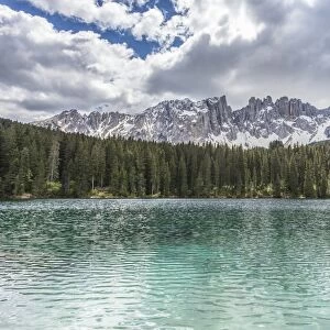 The still deep water of Lake Carezza surrounded by the picturesque frame of the Dolomites, in the Eggental in South Tyrol, Trentinto-Alto Adige, Italy, Europe