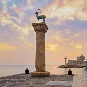 Deer and Doe on columns at entrance to Mandraki Harbour, former Colossus of Rhodes location, Saint Nicholas Fortress in the background, sunrise, Rhodes City, Rhodes Island, Dodecanese, Greek Islands, Greece, Europe