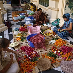 Devotees making garlands at Krishna-Balaram Hindu temple, Vrindavan, Uttar Pradesh, India