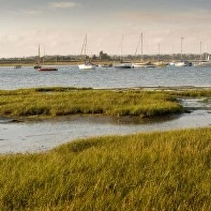 Distant view of church at Bosham, Chichester Harbour at high tide, West Sussex, England, United Kingdom, Europe