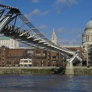 The Dome of St. Pauls Cathedral and Millennium Bridge over the River Thames