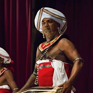 Drummer in a Pancha Thuryas Kandyan dance orchestra at tourist show in the Kandyan Arts Association Hall, Kandy, Sri