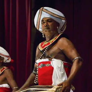 Drummer in a Pancha Thuryas Kandyan dance orchestra at tourist show in the Kandyan Arts Association Hall, Kandy, Sri