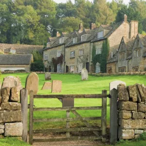 Dry stone wall, gate and stone cottages, Snowshill village, The Cotswolds