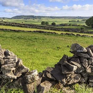 Dry stone wall, with view across a beautiful typical country landscape in spring