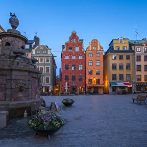 Dusk over the colorful facades of townhouses in the medieval Stortorget Square, Gamla