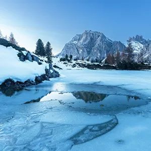 Dusk on the frozen lake of Limides, Falzarego mountain pass, Dolomites, South Tyrol, Italy, Europe