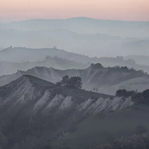 Dusk over hills where many layers are covered by fog, Emilia Romagna, Italy, Europe