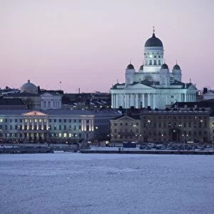 Dusk light on the Lutheran Christian cathedral in winter snow, across the frozen Baltic Sea
