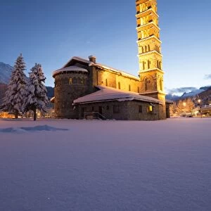 Dusk and lights on the church surrounded by snow Sankt Moritz, Engadine, Canton of Grisons