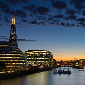 Dusk settles over London after sunset along the River Thames, with the Shard, London