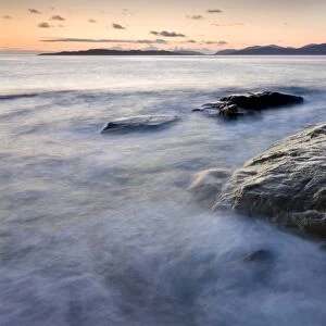Dusk view towards Taransay and the Isle of hills of North Harris from Borve Beach