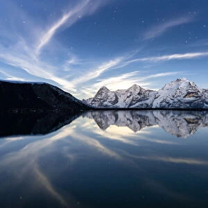 Eiger, Monch and Jungfrau mountains mirrored in Engital lake under the stars, Murren Birg
