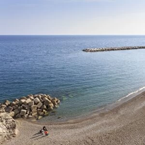 Elevated view of Atrani beach with family and fishing boats, near Amalfi, Costiera Amalfitana