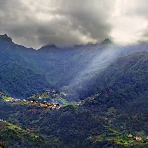 Elevated view of a remote village and tree covered hills and mountains near Sao Vicente