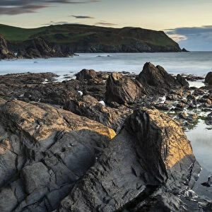 Evening sunlight on the rocky shores of Hope Cove, Devon, England, United Kingdom, Europe