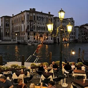 Evening view of a restaurant beside the Grand Canal, Venice UNESCO World Heritage Site