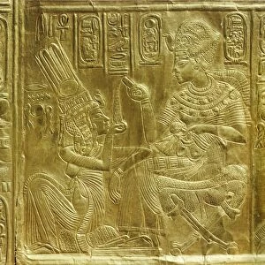 Detail of the exterior of the gilt shrine showing the king pouring perfumed liquid into the queens hand, from the tomb of the pharaoh Tutankhamun, discovered in the Valley of the Kings, Thebes, Egypt, North