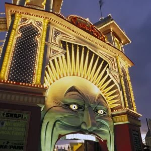 Exterior of Luna Park entrance illuminated at twilight, St. Kilda, Melbourne