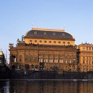 Exterior of the National Theatre (19th century) bathed in reddish glow of setting sun